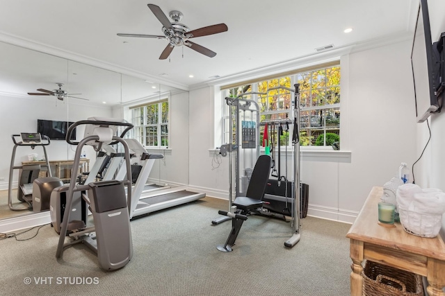 exercise area with baseboards, visible vents, ornamental molding, and carpet flooring