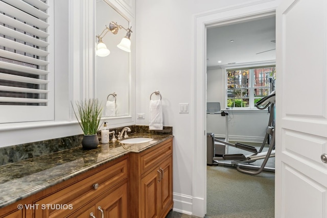 bathroom with baseboards, vanity, and radiator