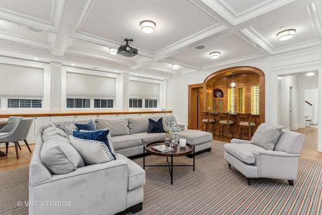 living area featuring beamed ceiling, coffered ceiling, and crown molding