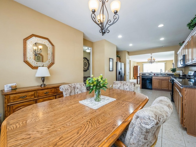 dining room featuring a chandelier, light tile patterned flooring, and sink