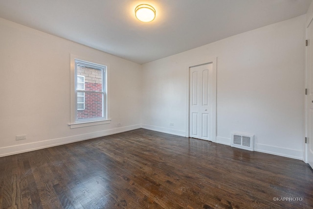 unfurnished room featuring dark wood-type flooring