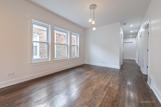 unfurnished room with dark hardwood / wood-style floors