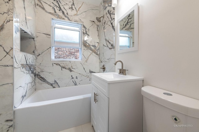 full bathroom with vanity, toilet, and tiled shower / bath