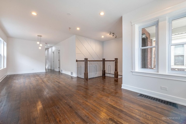 spare room featuring dark hardwood / wood-style flooring