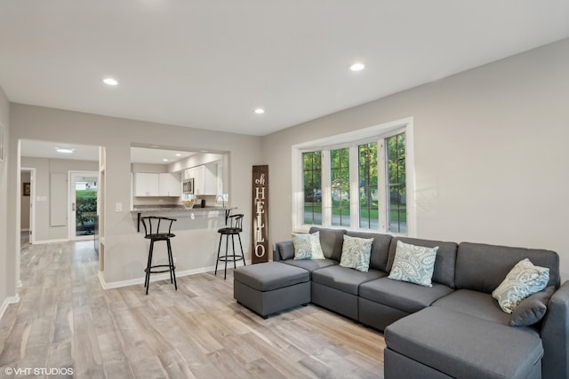 living room with plenty of natural light and light wood-type flooring