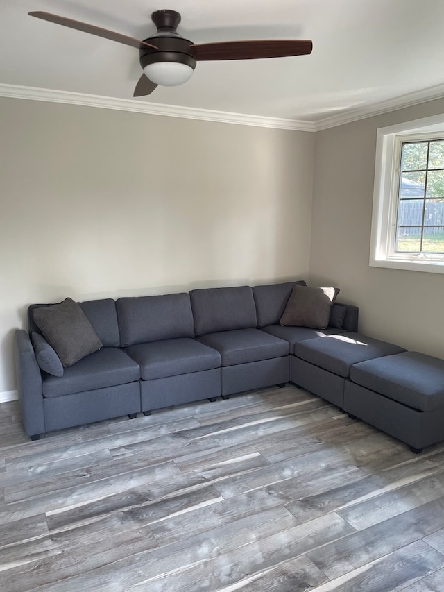 unfurnished living room with wood-type flooring, ceiling fan, and crown molding