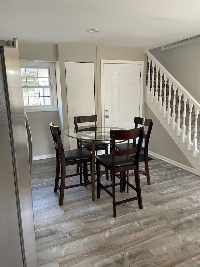 dining space with hardwood / wood-style flooring