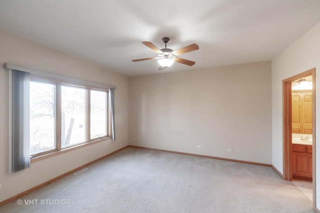 carpeted empty room featuring ceiling fan