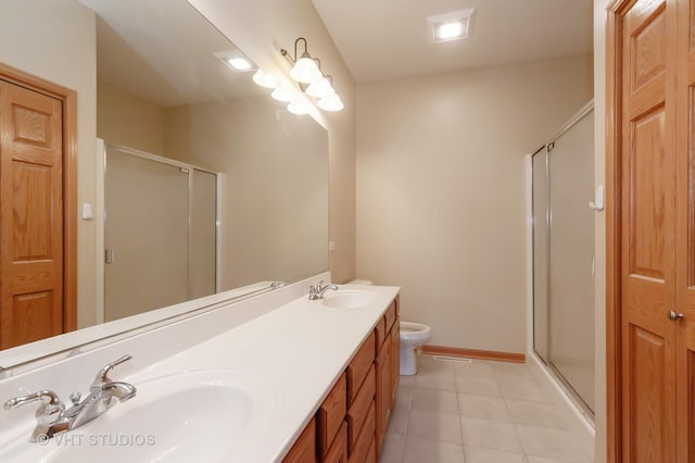 bathroom featuring tile patterned floors, vanity, a shower with shower door, and toilet