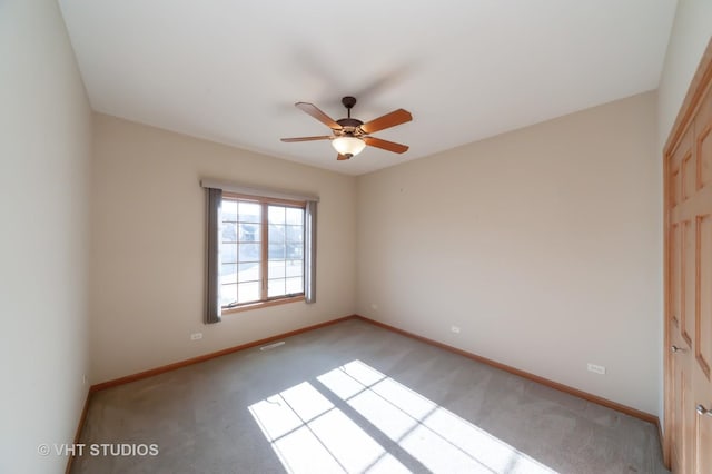 spare room with light carpet and ceiling fan