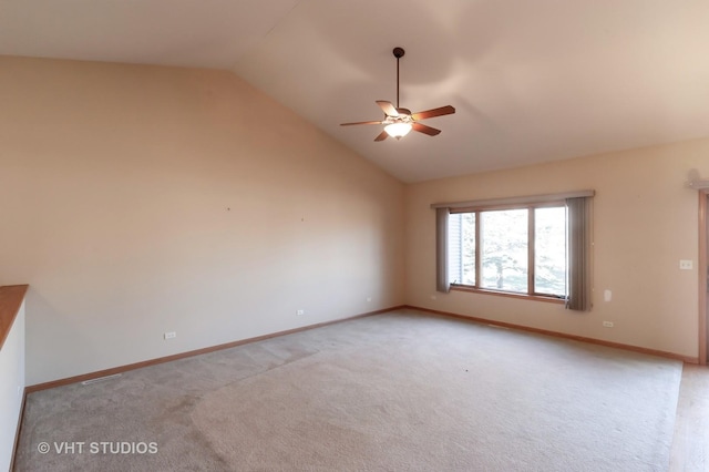 carpeted empty room featuring ceiling fan and lofted ceiling