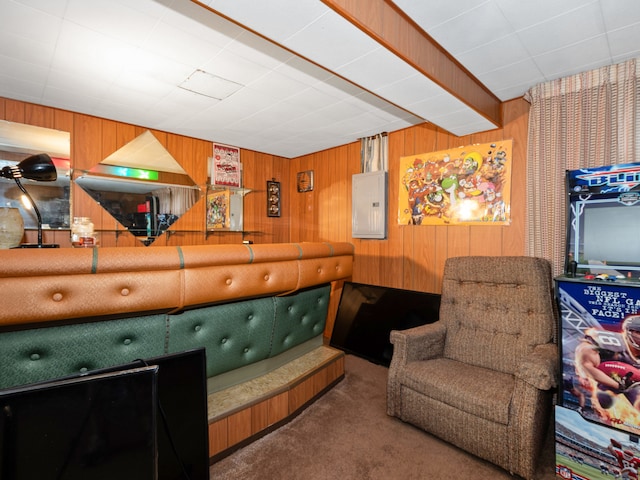 sitting room with carpet flooring, electric panel, and wood walls