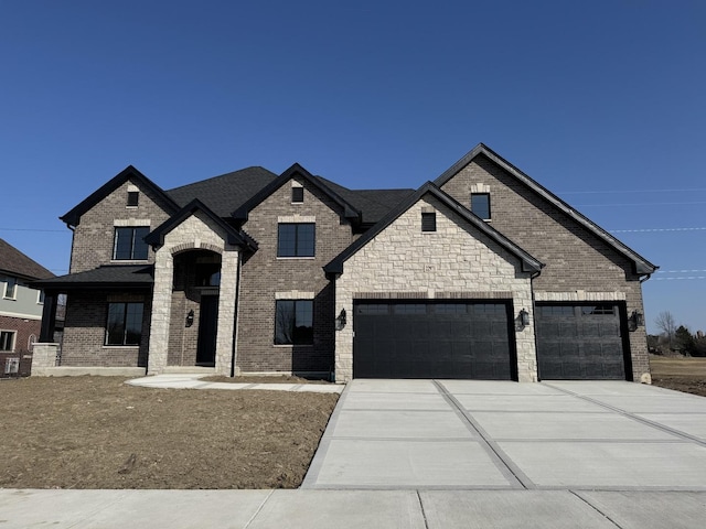 french country inspired facade featuring a garage, brick siding, and driveway