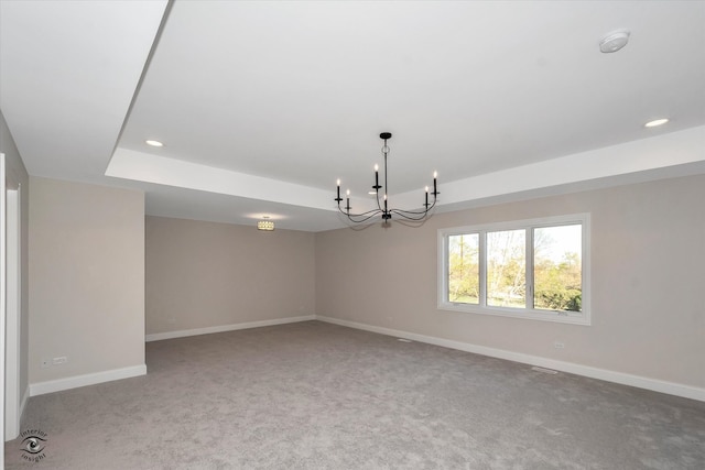 interior space with a notable chandelier and a tray ceiling