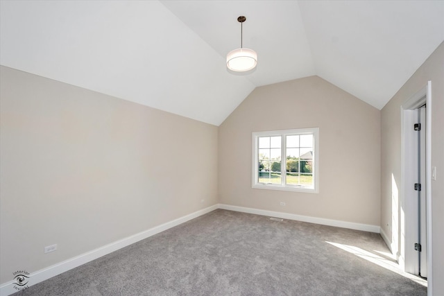 interior space with carpet and vaulted ceiling