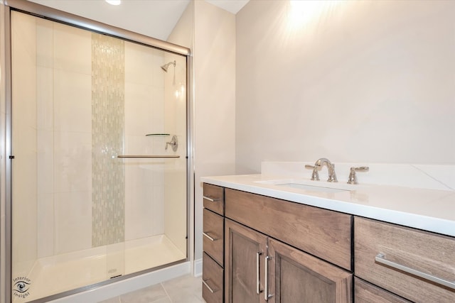 bathroom with tile patterned floors, vanity, and walk in shower