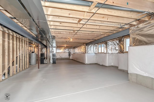 basement featuring heating unit and water heater