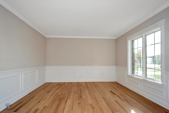 spare room featuring light hardwood / wood-style flooring and ornamental molding