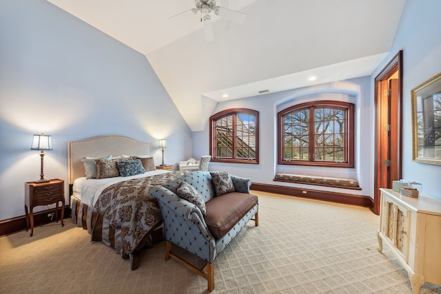 bedroom with light colored carpet, ceiling fan, and lofted ceiling