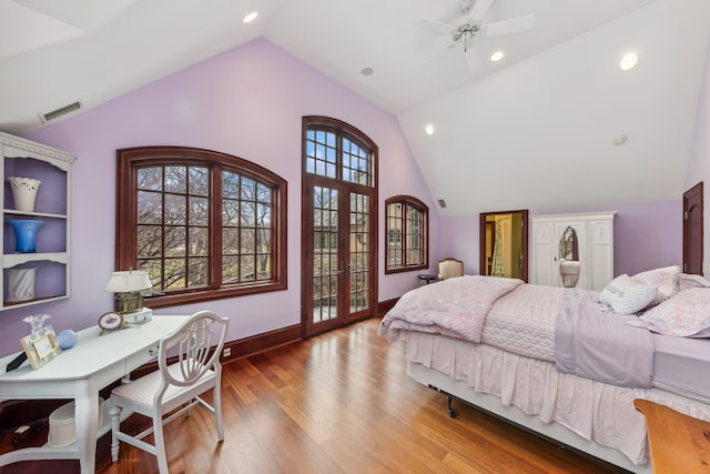 bedroom featuring ceiling fan, light hardwood / wood-style flooring, and lofted ceiling