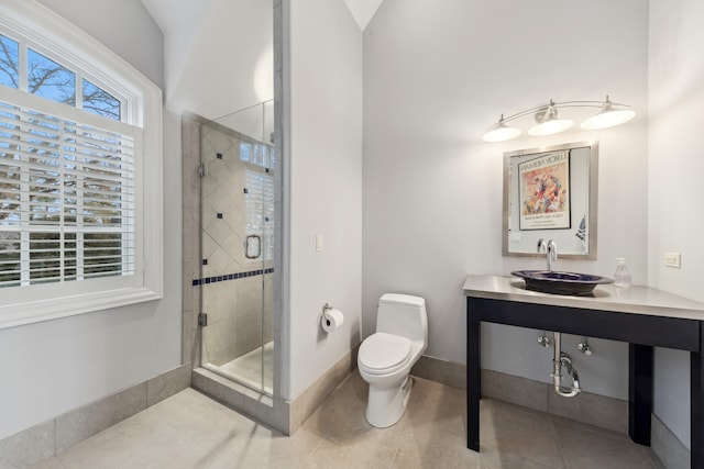 bathroom featuring tile patterned floors, walk in shower, vanity, vaulted ceiling, and toilet