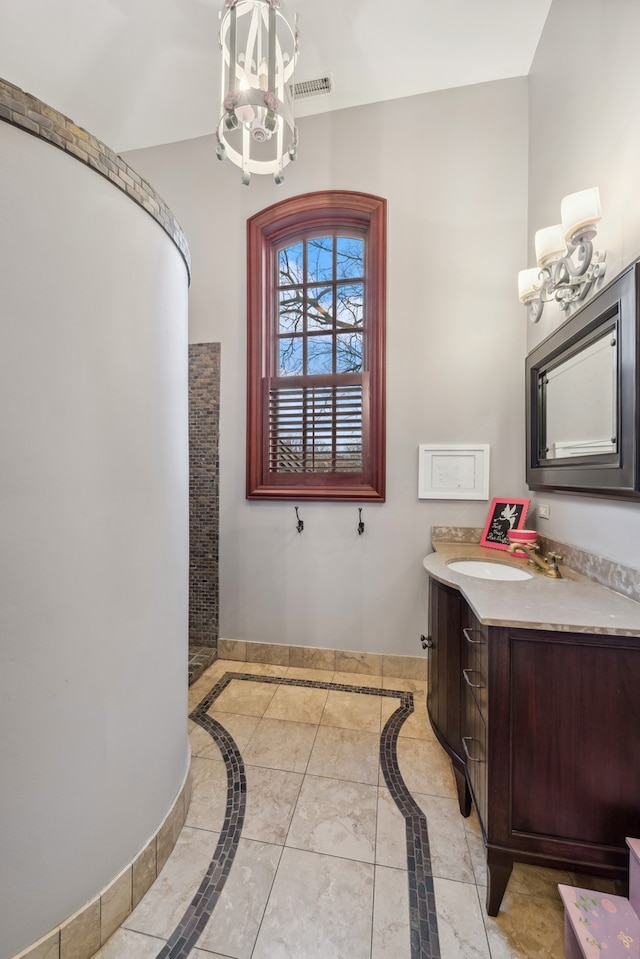 bathroom featuring a chandelier, vanity, and tile patterned flooring