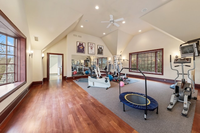 workout area featuring hardwood / wood-style floors, ceiling fan, and lofted ceiling