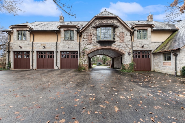 french provincial home featuring a garage