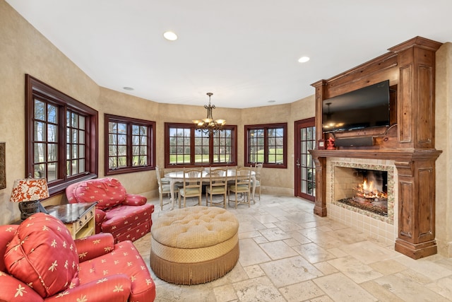 living room featuring a fireplace and a notable chandelier