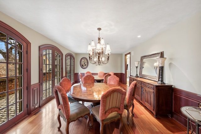 dining room with a notable chandelier and light wood-type flooring