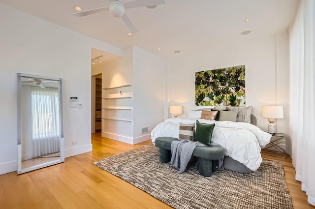 bedroom with ceiling fan and light hardwood / wood-style flooring