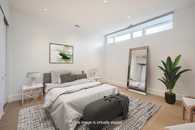 bedroom featuring a closet and light tile patterned floors