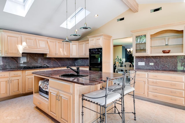 8542 W 132nd Pl, Palos Park, IL 60464 - kitchen featuring a skylight, a sink, light tile patterned floors, black appliances, and a kitchen breakfast bar