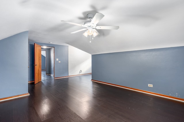 bonus room with ceiling fan, dark hardwood / wood-style flooring, and vaulted ceiling