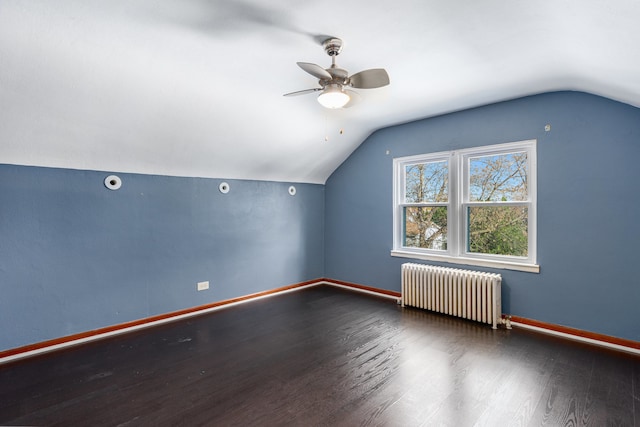 additional living space featuring hardwood / wood-style flooring, radiator, lofted ceiling, and ceiling fan