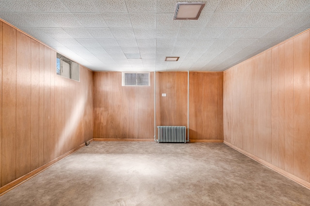 empty room with wooden walls and radiator