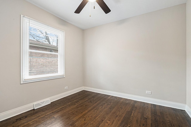 empty room featuring dark hardwood / wood-style flooring and ceiling fan