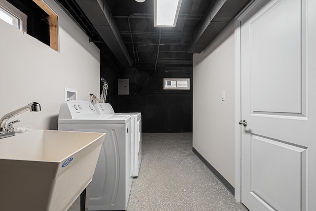 clothes washing area with sink and independent washer and dryer