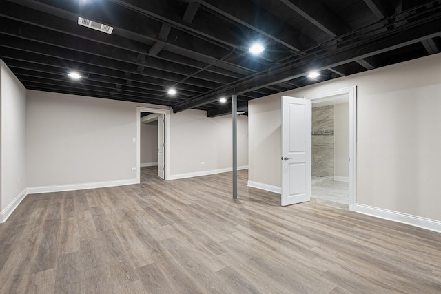 basement featuring hardwood / wood-style floors