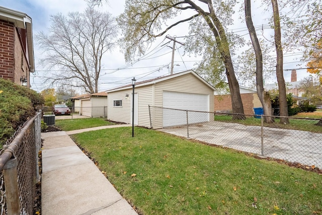 view of home's exterior featuring an outbuilding, a garage, a yard, and central AC