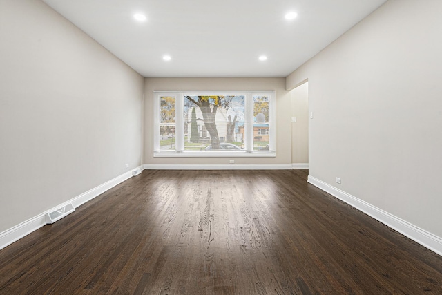 unfurnished room featuring dark wood-type flooring