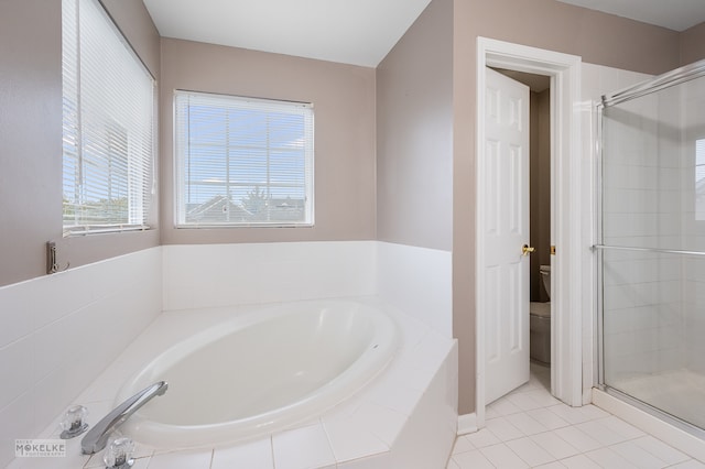 bathroom with tile patterned flooring, toilet, plus walk in shower, and a wealth of natural light