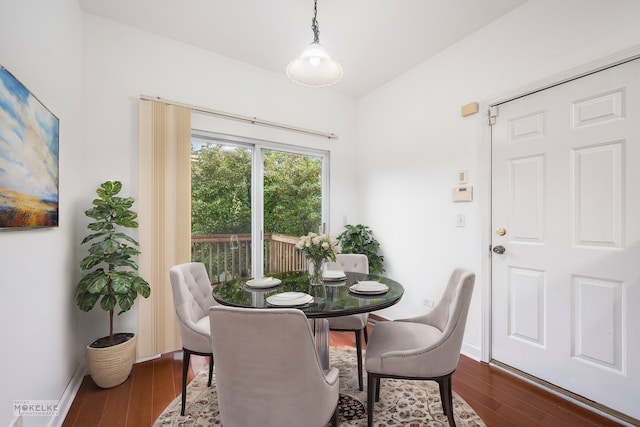 dining space with dark hardwood / wood-style floors