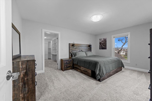 carpeted bedroom featuring connected bathroom