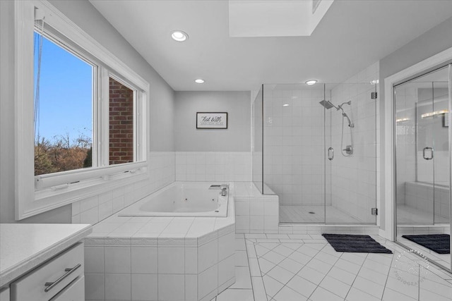 bathroom with tile patterned floors, vanity, and shower with separate bathtub