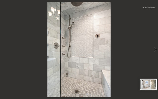 bathroom with a tile shower