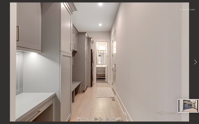 corridor with light hardwood / wood-style floors