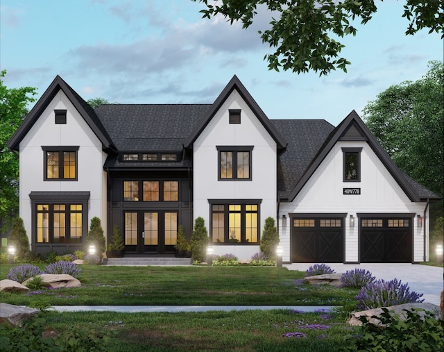 view of front of home featuring a front lawn, a garage, and french doors