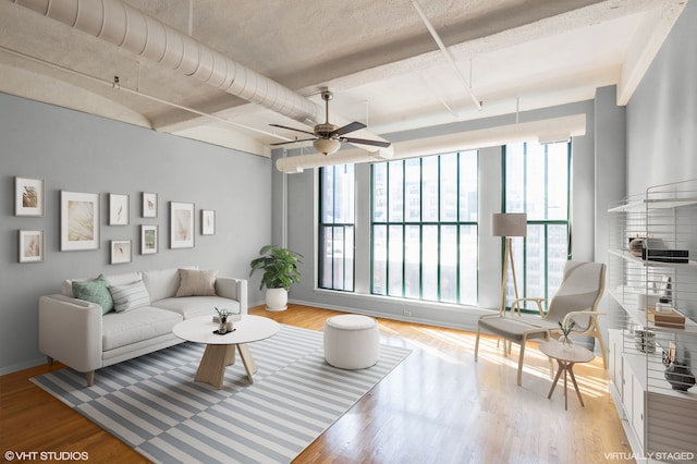 living room featuring ceiling fan, a healthy amount of sunlight, and light wood-type flooring