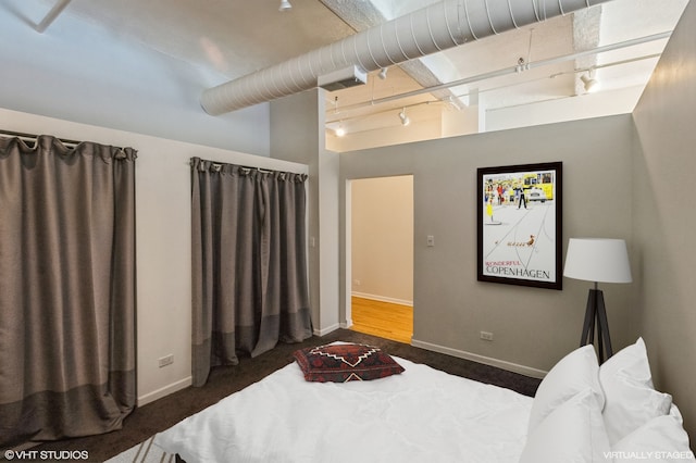 bedroom featuring dark carpet